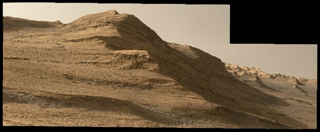 An ochre toned mosaic capturing a Martian landscape on the slopes of Mount Sharp in Gale Crater. The view features the Mishe Mokwa butte as the central, closer subject, and the distant Yardang unit on the horizon at right.