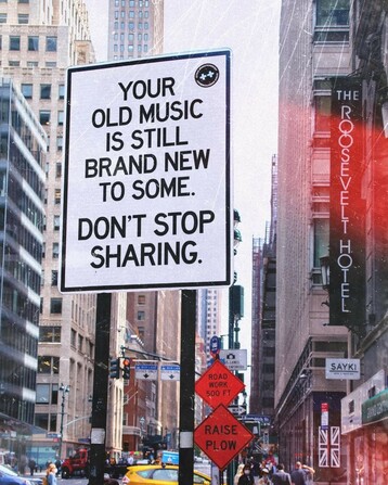 The image features a street scene in an urban environment, likely New York City, as indicated by the recognizable buildings and street signs. The focal point is a sign that reads, "Your old music is still brand new to some. Don't stop sharing." This message encourages the sharing of music, emphasizing that even older music can be new and enjoyable to others. The background includes tall buildings, a yellow taxi, and a sign for the Roosevelt Hotel, adding to the bustling city atmosphere. The image conveys a positive message about the enduring appeal of music and the importance of sharing it with others.