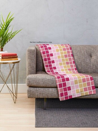 Abstract grid of multi-color squares printed on a throw blanket