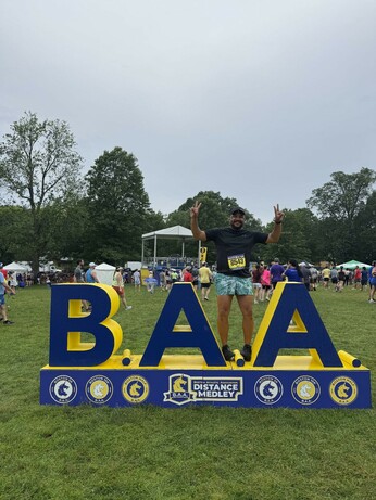 Me standing on top of the B.A.A Distance Medley. It's blue and yellow with giant BAA letters