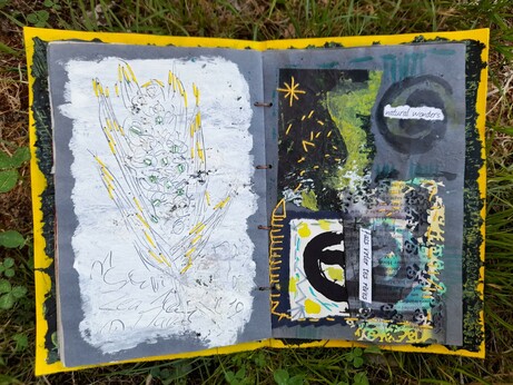 #11: The pages on blue krafft paper are very different. Left: a white acrylic paint surface in which a corn cob and words for corn in different languages are engraved. Yellow stitches and applied bright red glass beads (for the corn) enhance the forms. Right: Abstract collage with black tissue paper, white painted paper and paper lace made with an old book page. Some yellow embroidery. All colours are mainly yellow, some green and red, beside white and black. The words: 'natural wonders' and 'fais voler tes reves' (let your dreams fly).