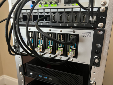 A racknex SBC 308 shelf with five Raspberry Pis installed and running.