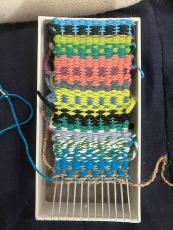 weaving on the tiny little homemade box loom