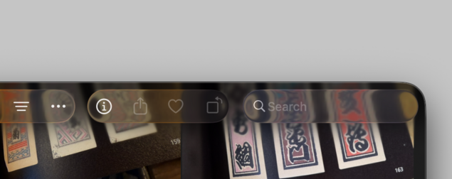 A screenshot of the Photos app on macOS Tahoe, with Liquid Glass toolbar buttons, icons, and a search field, which blend so much into the content that they’re barely noticeable.
