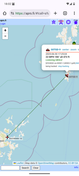 A screen shot from my mobile phone showing a map on the aprs.fi website that indicates my position on Shetland and the receiving station on Orkney.  Shetland is at the top right hand corner of the image and Orkney is at the bottom left. There is a green diagonal line between the two showing the signal path.