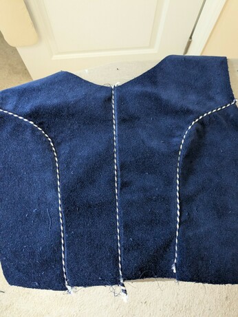 The back view of a dirndl with piping at the seams.