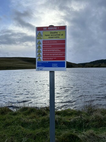 A Scottish notice. A little more wordy, but it comes down to deep water is dangerous, swim at your own risk, but by the way, in emergencies here is a telephone number and here is the map reference if there are problems.