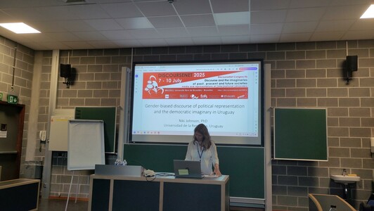 A person in front of a presentation slides.