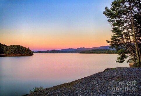 Image of South Holston Lake in Northeast Tennessee in late evening, with soft pink clouds reflecting in the water. This long exposure artwork is from the Fine Art Gallery of Shelia Hunt.