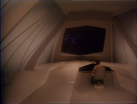 Carl Sagans ship of imagination, It's a bare room with console in the center, and viewscreen front and center. There's a raised ledge on each side. One would be good for seating, and the other with a bed on it. It's dimly lit, with a glow warmer than amber. Kind of a peachy brown. For as spartan as it is, it looks warm and inviting. No glaring bright lights.