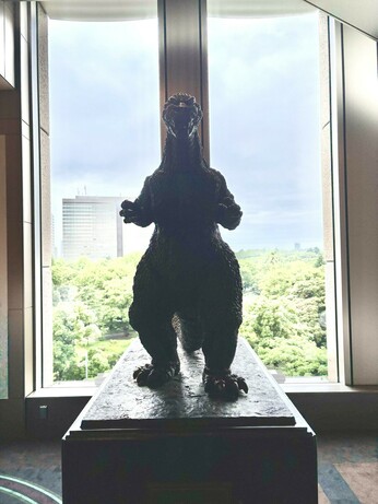 Indoors is a slightly smaller bronze Godzilla statue, designed to look like the original 1954 version. Godzilla is posed upright with his arms raised.