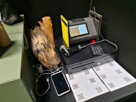 A homemade cash register setup at a show, on top of a cash drawer.
