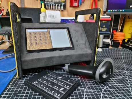 A homemade cash register with receipt printer, keypad, touchscreen, and barcode reader.