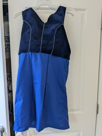 The back view of a dirndl with piping at the seams.