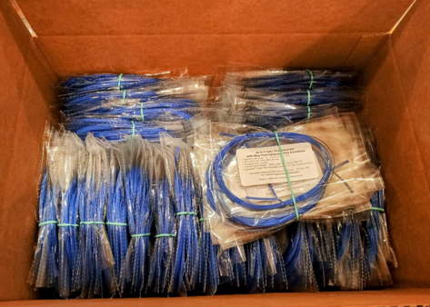 a photo of a cardboard box with blue wires that are T-type thermocouple temperature sensors.