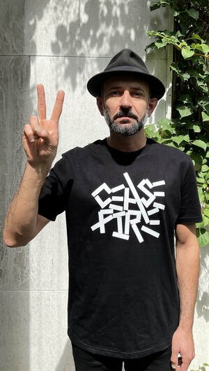 I’m wear my designed CEASEFIRE black t-shirt, and show victory sign.