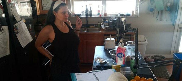 My SO stands in a kitchen, at an island counter, with baking supplies on it.