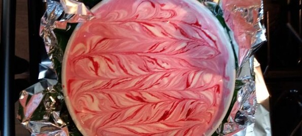 Looking down on a lemon raspberry cheesecake, fresh out of the oven.