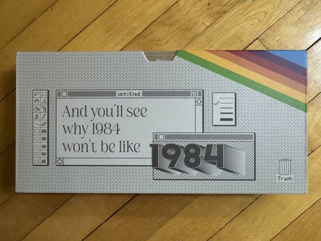 The packaging of the keycap set, inspired by a MacPaint window, with the toolbar to the left. The window says "And you'll see why 1984 won't be like" and then another window says "1984".

There's an Apple logo rainbow in the upper right!