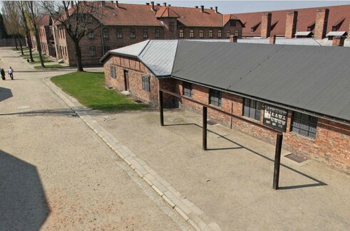 Aerial view of Auschwitz concentration camp showing brick buildings and the gallows in front of the kitchen building.