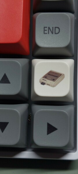 A detail of the rightmost column of keys. A white key has a little SuperNES console printed on it.
