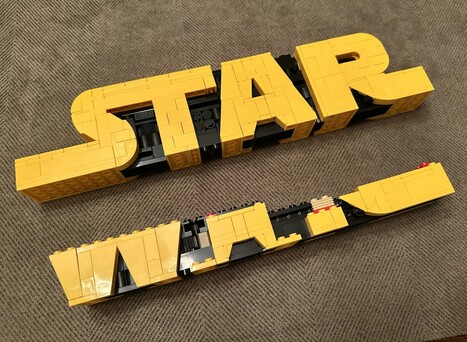My LEGO Star Wars logo set two bags away from completion with “Star” done and the lower “Wars” about half way built.