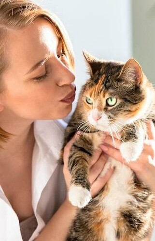 A woman ready to kiss her beautiful kitty