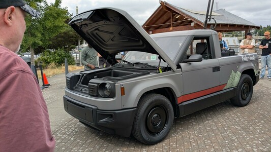 Photo of the Slate.auto truck with its hood open.