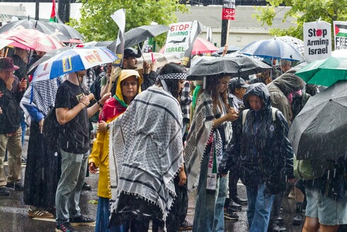 A group of protesters in driving rain