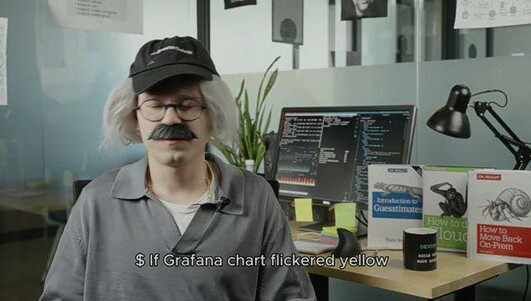 An old-school systems engineer in his office,
the subtitles say: "If Grafana chart flickered yellow while no one was watching, did the latency truly spike?"

You can see his monitor with several SSH connections opened, and 3 oreilly books on the table.
The red color book title is "How to move back on-prem", the green color book title is "How to cloud", and the blue color book title is "Introduction to guesstimates"