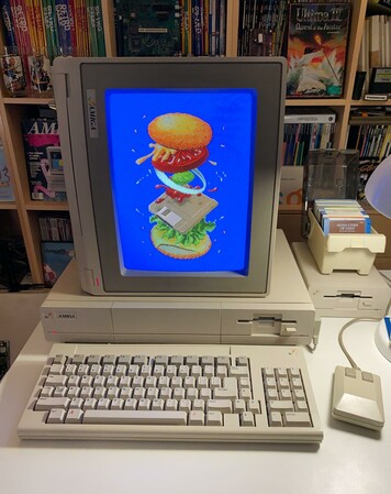 The Commodore Amiga computer, here showing a recreation of the famed "Four-Byte Burger" by Jack Haeger, recreated by Ahoy, with the CRT rotated 90-degrees to display the image as intended (photo is Blake Patterson's original content)