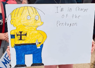 via @hypocrisyhammer on Ig
A picture of a sign at a protest showing Pete Hegseth drawn shirtless in the Simpsons style (as Ralph Wiggum) with his white supremacist tattoos showing. He's holding a bottle. In crude handwriting it says "I'm in charge of the Pentagon."

I don't know where the photo was taken, but salute to the artist!