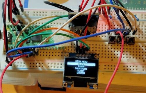 Raspberry pi Pico and an oled display showing a test menu