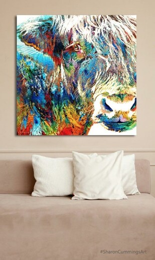 Colorful Highland Cow over a sofa with pillows by artist Sharon Cummings.