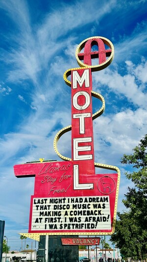 A colorful vintage motel sign featuring the word "MOTEL" in large letters. The sign includes quirky text that states, "Llamas Stay for Free" and a humorous message about dreaming of disco music making a comeback. At first I was afraid, I was petrified. A line from the disco song I Will Survive.