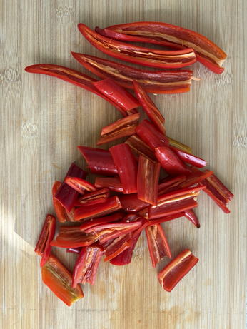 A chopping board of chopped and deseeded chillis
