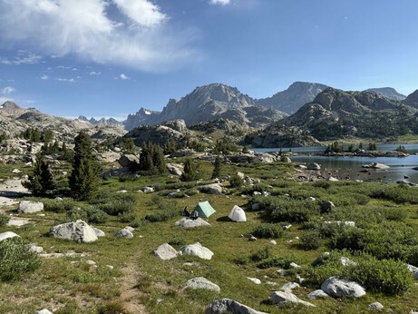 View of our camp looking at Fremont Peak in the background. You can see two tents set up in a grassy field.