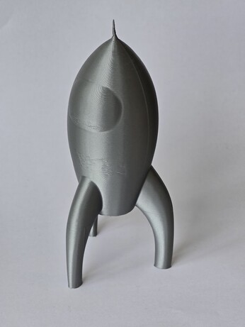 a silver grey fairy dust, which is a kind of stylised space ship from 20th century science fiction