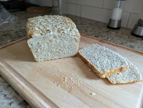 Loaf with a couple slices cut off and set aside, displaying the crumb.