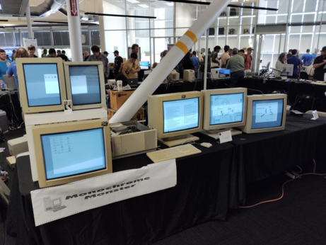 6 old monitors connected to a macintosh quadra 950 laying on its side.