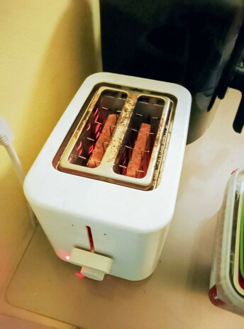 Toast toasts in the toaster, round side down.