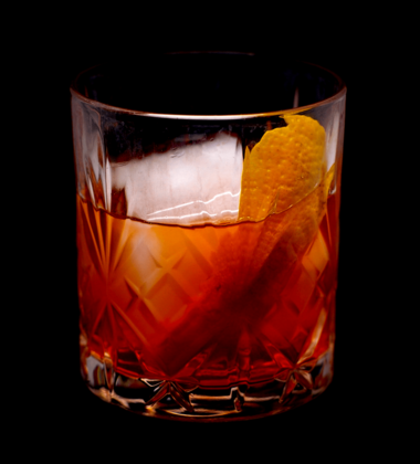 The cocktail itself in a tumbler with a big chunk of ice and garnish with an orange twist