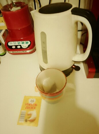 The kettle is on, and a rainbow cup with a