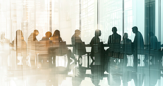 Abstract image of a group of people meeting in a conference room
