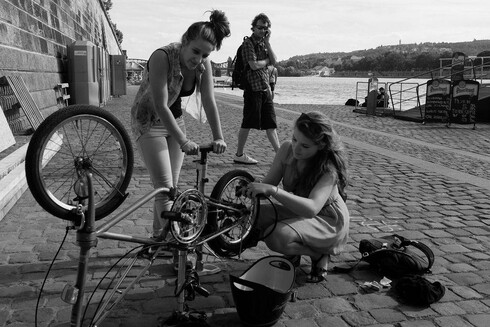 stuff breaks: photograph of two women repairing a bicycle on a cobbled street. Photo attribution: Flickr user pedrosek