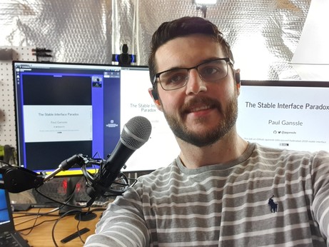A selfie of Paul about to give his talk, "The Stable Interface Paradox" at PyConf Hyderabad 2020. There is a microphone and some monitors in the background.