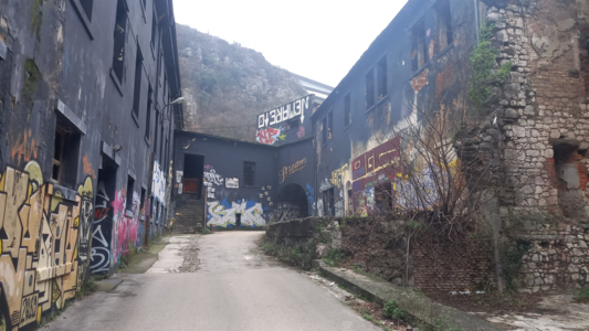 The abandoned buildings in the river's ravine. A tunnel in the building leads further down the ravine.