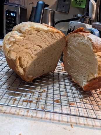 A fresh loaf of bread, sliced and sitting on a cooling rack. Mmmmm.