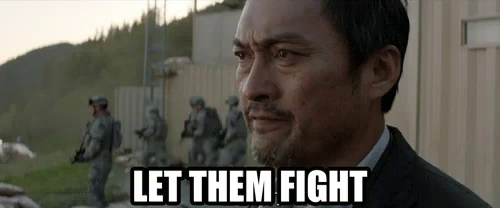 Meme: image from the Godzilla movie, a commander counseling to "Let them fight" regarding a giant monster combat.
