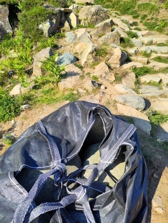 Photo taken In the Lake District, Cumbria, England. Helicopters transport bags of rock used to construct hiking path on The National Trust's land. 